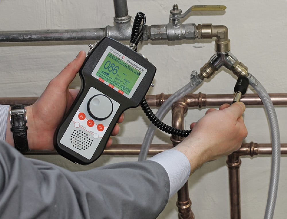 Plumber testing pipes with electronic leak detection equipment in Evans