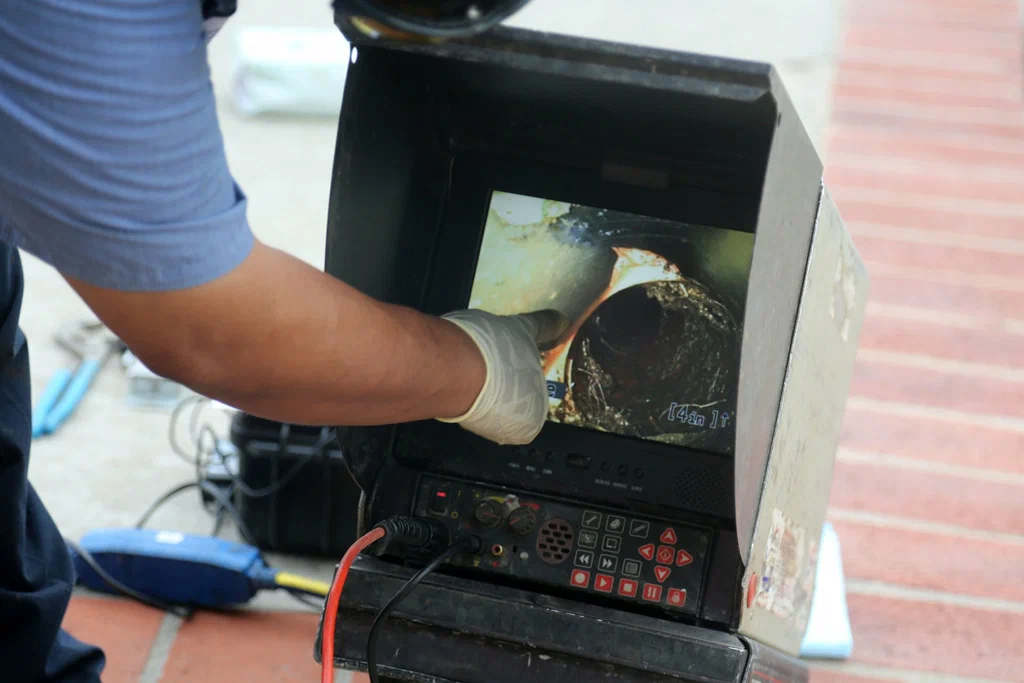 Technician viewing a drain inspection camera in Evans